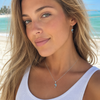Model wearing Larimar dolphin necklace and earring set in sterling silver on Florida Gulf Coast beach — Crabby Mermaid