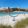 Larimar octopus necklace on natural Portuguese cork cord hanging from driftwood on Florida Gulf Coast beach - genuine Dominican Republic Larimar - Crabby Mermaid