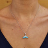 Sterling silver aqua crystal whale tail necklace on model showing pendant detail — handcrafted in Ireland — Crabby Mermaid
