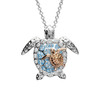 Sterling silver and rose gold mother and baby sea turtle necklace with aquamarine and white crystals on white background — handcrafted in Ireland