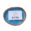 Spring showers coconut shell candle on sandy beach with driftwood and seashells — blue soy coconut wax candle — Crabby Mermaid