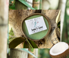 Indulge in a soothing spa-like experience with this 5.5oz Bamboo and Coconut Half Shell Coconut Candle. The scent transports you to a tranquil bamboo forest filled with the top notes of luscious lime blossom, cool mint, and refreshing ozone, blended with notes of lush tropical flavor. Enjoy a peaceful and relaxing atmosphere, perfect for any home.