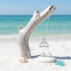ShanOre platinum plated Trinity Knot pearl and Swarovski crystal necklace hanging from driftwood at Florida Gulf Coast beach with matching earrings - Crabby Mermaid
