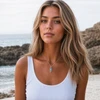 Model wearing Sterling Silver Aqua Crystal Jellyfish Necklace with white top by the ocean — Crabby Mermaid