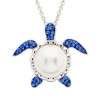 Sterling silver sea turtle pendant with freshwater pearl body and sapphire crystal flippers on white background - handcrafted in Ireland - Crabby Mermaid