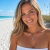 Sterling silver mom and baby starfish necklace with aqua crystals worn on model at Florida beach - handcrafted in Ireland - Crabby Mermaid