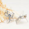 Sterling silver octopus stud earrings with freshwater pearl and aquamarine crystals displayed on seashell — handcrafted in Ireland — Crabby Mermaid