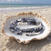 Stone Wrap Sodalite Silver coiled in a seashell on a white sand Florida Gulf Coast beach — Crabby Mermaid