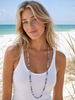 Stone Wrap Sodalite Silver worn as a single strand necklace on a model at a Florida Gulf Coast beach — Crabby Mermaid