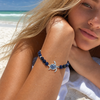 Sterling silver lapis sea turtle stretch bracelet worn on model at Florida Gulf Coast beach - handcrafted in Ireland - Crabby Mermaid