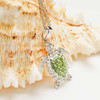 Sterling Silver Peridot Green Crystal Turtle Necklace displayed on seashell — Crabby Mermaid