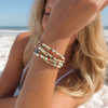 Stone Wrap Aqua Terra worn wrapped on the wrist of a model at a Florida Gulf Coast beach - Crabby Mermaid