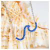 Elegant wave-shaped pendant necklace in sterling silver with sparkling blue crystals, perfect for ocean and beach lovers.
