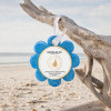 Spongellé Freesia Pear Wild Flower buffer hanging by white ribbon from driftwood on Florida Gulf Coast beach — Crabby Mermaid