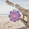 Spongellé French Lavender Wild Flower buffer hanging by white ribbon from driftwood on Florida Gulf Coast beach - Crabby Mermaid