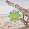 Spongellé Coconut Verbena Wild Flower buffer hanging by white ribbon from driftwood on Florida Gulf Coast beach — Crabby Mermaid
