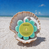 Spongellé Coconut Verbena Wild Flower body wash buffer nestled in seashell on white sand Florida beach — Crabby Mermaid