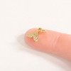 Gold CZ mermaid tail charm size reference shown on fingertip — 10mm x 10mm — 18K gold PVD stainless steel