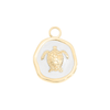 Close-up of white epoxy sea turtle medallion charm in 18K gold PVD finish on white background - Crabby Mermaid