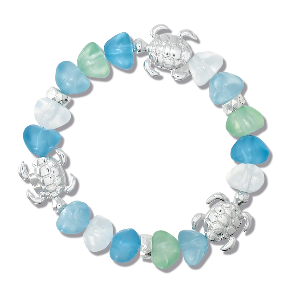 Sea glass turtle stretch bracelet with blue green and white frosted glass beads and silver turtle accents on white background - Crabby Mermaid