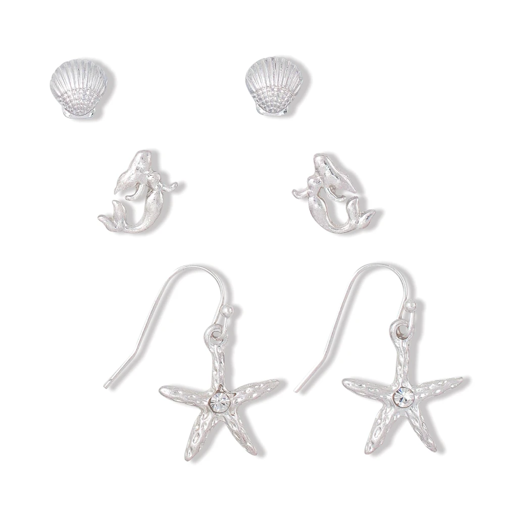 Silver-toned shell stud, mermaid stud, and starfish dangle earrings with crystal detail on white background - coastal earring set - Crabby Mermaid