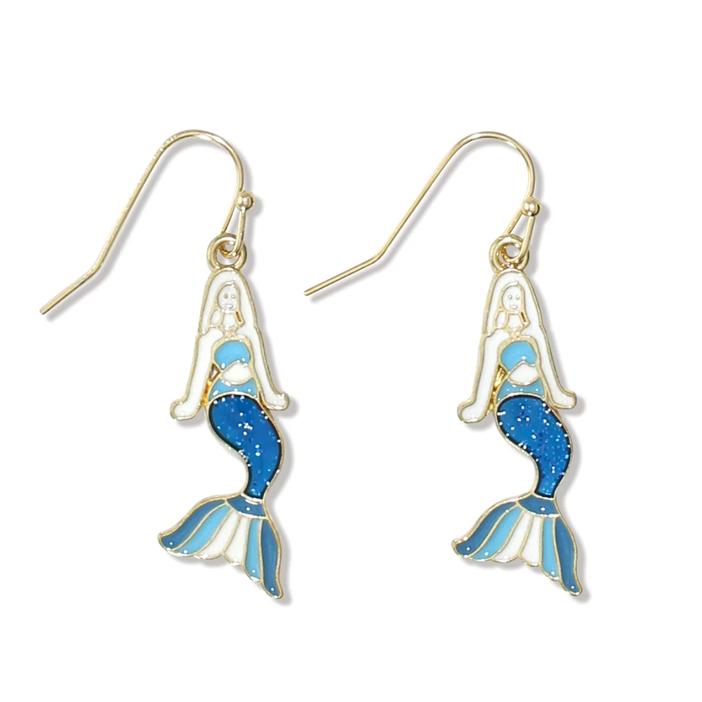 Gold-toned mermaid dangle earrings with white enamel body and blue glitter scales on white background - coastal jewelry - Crabby Mermaid