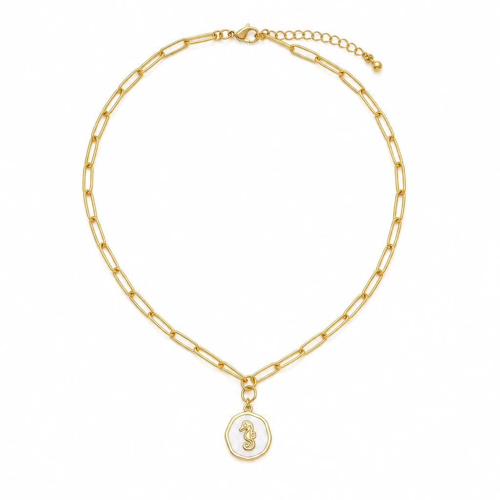 Gold paperclip chain necklace with white epoxy seahorse charm on white background - Crabby Mermaid