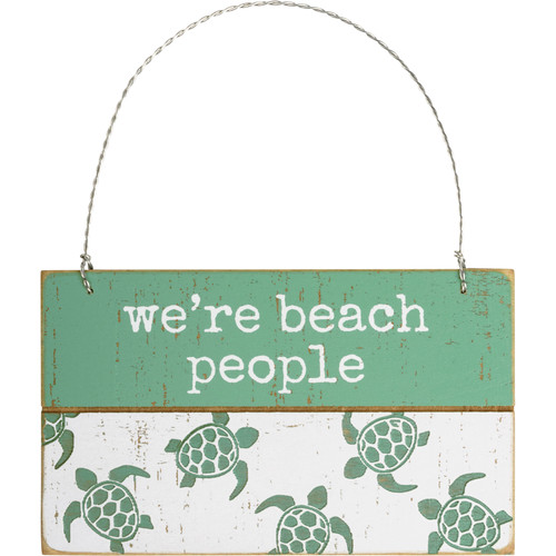 We're Beach People Ornament
A rustic slat wood ornament featuring "We're Beach People" sentiment and debossed sea turtle designs in a beach-inspired palette. Hangs easily by twisted wire loop. 
Perfect for your ocean-inspired holiday tree, gift wrap, coastal decor, and more!
Dimensions:5" x 3" x 0.25"
Material:Wood, Wire
Product Text:WE'RE BEACH PEOPLE