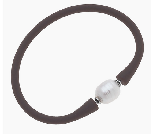 Bali Freshwater Pearl Silicone Bracelet in Chocolate Brown
Resort-chíc has never looked so good! 100% waterproof & made with genuine Freshwater pearls, our best-selling Bali Bracelets are a must-have accessory! Simply roll on & off your hand, or open & close at the pearl, to create the perfect arm party for every occasion.

MATERIAL: Silicone Band & Freshwater Pearl - 100% Waterproof!

SIZE: 2.5" Diameter Due to the one-of-a-kind nature of the medium, shape, size & color of the pearl may vary slightly, as they reflect the natural beauty of freshwater pearls.