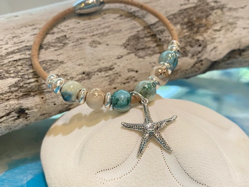 Close-up of sterling silver starfish charm on glazed ceramic bead cork bracelet ‚Äî eco-friendly sustainable natural Portuguese cork ‚Äî Crabby Mermaid