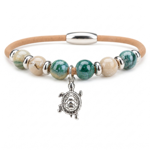 Cork bracelet with green and cream ceramic beads and sterling silver turtle charm on white background — Crabby Mermaid