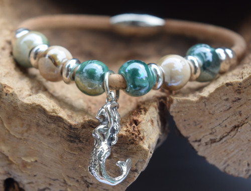 Close-up of sterling silver mermaid charm on glazed teal and beige ceramic bead cork bracelet ‚Äî eco-friendly sustainable natural Portuguese cork ‚Äî Crabby Mermaid