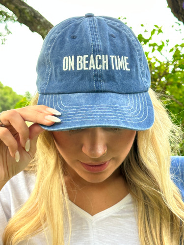 On Beach Time Baseball Cap

A cotton baseball cap with an adjustable brass closure on the back. Features box sign style "On Beach Time" sentiment embroidered in cream onto a weathered navy blue base.

One size fits most. 
Hand-wash only.