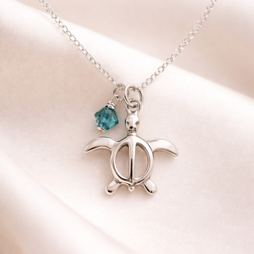 Honu sea turtle necklace in sterling silver with indicolite crystal charm on neutral background — Crabby Mermaid