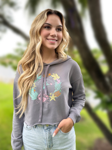 Coastal Wreath Women's Crop Hoodie - Storm

A Crabby Mermaid original, this trendy women's cropped hoodie sweatshirt is a must-have for your fall wardrobe. Made of 52% cotton and 48% fleece, this incredibly soft sweatshirt is so comfortable you'll never want to take it off. In addition, the hoodie will keep you nice and warm on those cooler days. With our original coastal wreath artwork, you won't find this design anywhere else; own an original! Pair this grey hoodie with your favorite jeans for a comfortable casual look, or wear it over a tank or tee for extra warmth with layers. It's light enough that even us Florida girls can wear it; I pair mine with shorts on cooler days, and it's a perfect combination.

52% combed and ring-spun cotton, 48% poly fleece