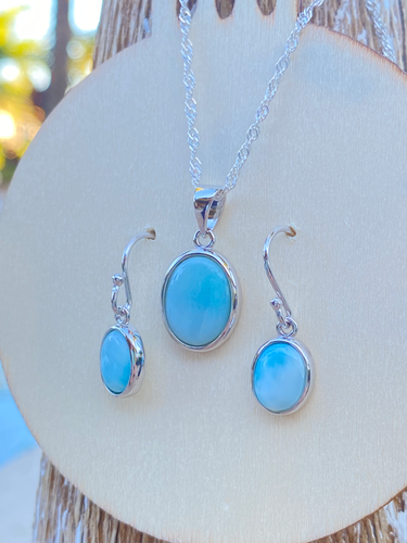 Larimar oval necklace and earring set in sterling silver displayed on wood disc — genuine Dominican Republic Larimar — Crabby Mermaid