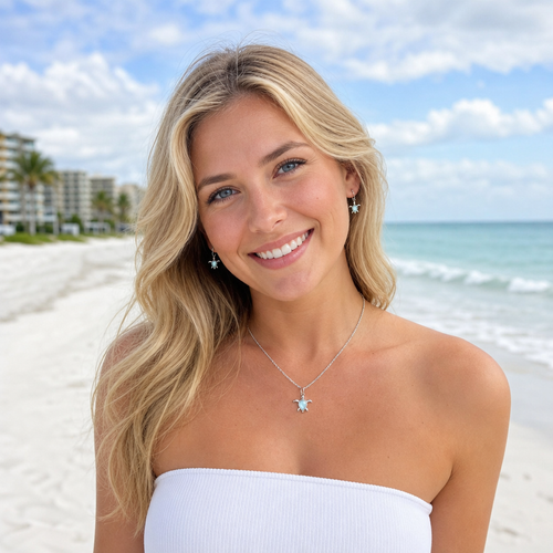 Sandy blonde model wearing Larimar sea turtle necklace and earring set in sterling silver at Naples Florida beach — genuine Dominican Republic Larimar — Crabby Mermaid