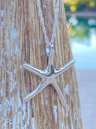 Sterling silver starfish necklace displayed on driftwood — coastal jewelry — Crabby Mermaid
Kiss, kiss, make a wish with this beautiful starfish Sterling Silver Pendant Necklace.

Starfish .925 Sterling Silver Pendant: 0.75 inch