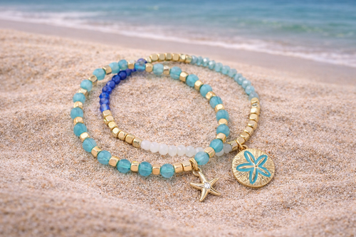 Mint gold beaded bracelet set worn on wrist showing starfish and sand dollar charms - beach jewelry - Crabby Mermaid