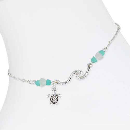 Hammered silver-tone wave and sea turtle charm anklet with turquoise and white sea glass style bead accents on white background ‚Äî coastal beach anklet ‚Äî Crabby Mermaid
Anklet comes with lobster claw clasp & 2" extender