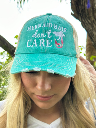 Mermaid Hair Don’t Care Trucker Hat

A day out on the water will do a number on anyone’s hair, but you won’t even mind when you’re wearing one of these cool “Mermaid Hair Don’t Care” Trucker Hats.

These hats feature a beautiful custom mermaid and text embroidery with the Mermaid Hair Don’t Care on intentionally distressed fabric for a cool vintage vibe look. With its vibrant teal color, this hat is a perfect look for all outdoor lovers. Perfect for those bad hair days when you are in a hurry. Face it, you know we all have them, so why not embrace them with style. They’re even perfect for ponytails.  

This hat is super comfortable and stylish for mermaid lovers of all ages. Just throw on this super-cute trucker hat and get out and enjoy the outdoors, while protecting your hair and face from the sun.



Hat details:

These trucker caps are embroidered with high-quality stitching and have a curved bill for added protection from the sun
The washed distressed style cap and contrast stitching gives it a worn vintage look
With an adjustable tab and a mesh back to easily fit your head and allow air to flow so they’re not as hot as a traditional hat and helps to keep you cooler on those hot summer days
The hat is made of 80% cotton and 20% polyester
This hat is one size fits most, making is perfect for kids, teens, and adults
The hat is a vibrant teal color with the words “Mermaid Hair Don’t Care” in white embroidered lettering and a beautiful embroidered white and pink mermaid


You can also check out our Mermaid Hair Don’t Care trucker hat in gray.  Grab one to match each outfit or give to a friend. You’re going to love it!