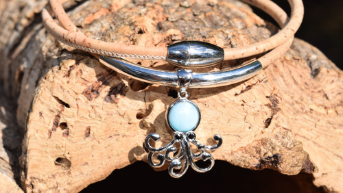 Larimar octopus necklace on natural Portuguese cork with sterling silver tube accent and magnetic ball clasp displayed on driftwood ‚Äî Crabby Mermaid