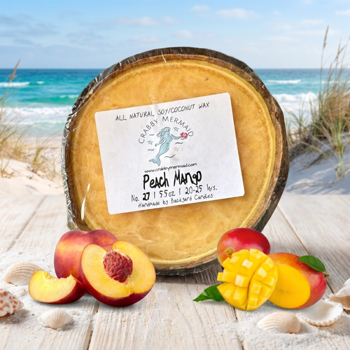 Peach mango coconut shell candle on beach boardwalk with fresh peaches and mango — tropical soy coconut wax candle — Crabby Mermaid