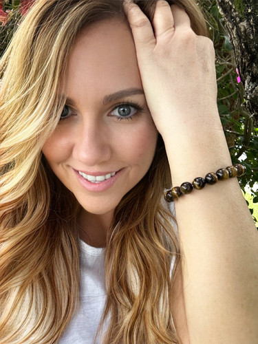 Tiger Eye Gemstone Beaded Stretch Healing Bracelet

Introducing the Gem Stone Beaded Stretch Spiritual Healing Bracelet. This beautiful and eye-catching bracelet features 10mm natural tiger eye gemstones strung on an elastic cord. Wearing the bracelet not only adds style to any outfit but is said to bring a sense of spiritual healing and insight. Its properties are known to foster balance and bring forth clarity, confidence, strength, and integrity to the wearer. Each gemstone bead is unique, and its distinct color can range from deep yellow to red-brown and gold. An elegant addition to your everyday wear.

Tiger’s Eye possesses attributes that enhance vitality. This gemstone is ideal if you strive to reclaim your strength and battle past psychological limitations. It also contains energetic influences which bring about wealth and prosperity.

Tiger’s Eye aids in transforming damaging emotions into more advantageous ones. It could assist you in modifying your outlook and seeing barriers as opportunities instead of impediments. This crystal can aid you in vanquishing trepidation and gaining confidence. With Tiger’s Eye, you can be reminded that whatever you focus on can be accomplished.