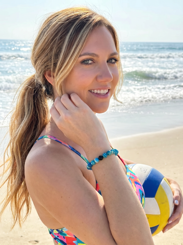 Woman wearing blue agate gemstone beaded bracelet with hand raised near face — Crabby Mermaid