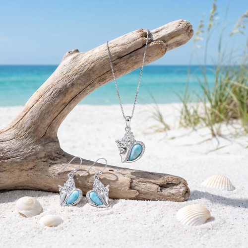 Larimar and cubic zirconia conch shell necklace and earring set on driftwood at Florida Gulf Coast beach ‚Äî hand assembled by Crabby Mermaid