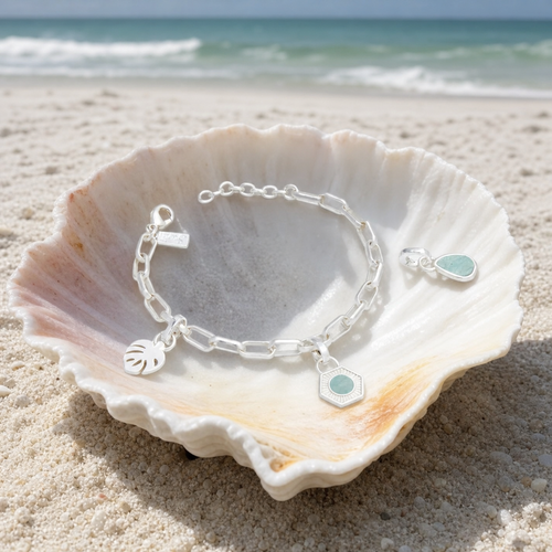 Interchangeable charm bracelet in sterling silver with amazonite charms in seashell on Florida Gulf Coast beach — Crabby Mermaid