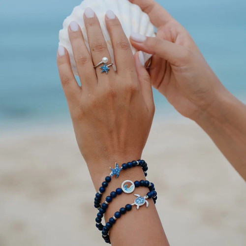 Add a touch of elegance and meaning to your style with the Ocean’s Sterling Silver Lapis Sea Turtle Stretchy Bracelet. Featuring lapis lazuli beads, a crystal-accented silver turtle centerpiece, and a comfortable stretchy design, this bracelet symbolizes wisdom, strength, and perseverance. Perfect as a gift or for yourself!