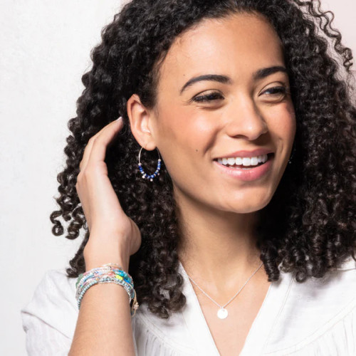 Model wearing minimalist Turquoise disc hoops, showcasing the sky stone’s natural veins against silver metal.
