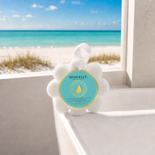 Spongellé Beach Grass Wild Flower body wash buffer on white bathtub edge with Florida beach view through window — Crabby Mermaid